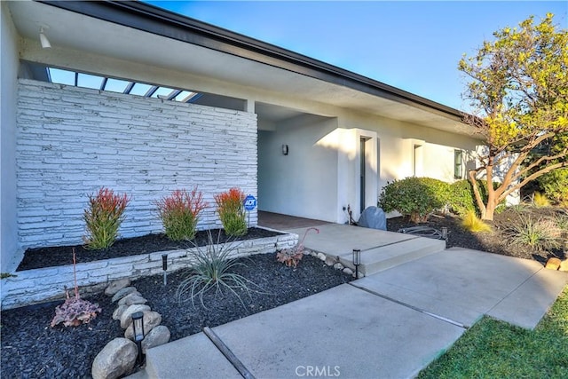 entrance to property with a patio