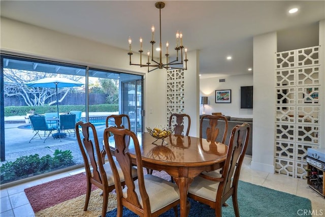 tiled dining area featuring a chandelier