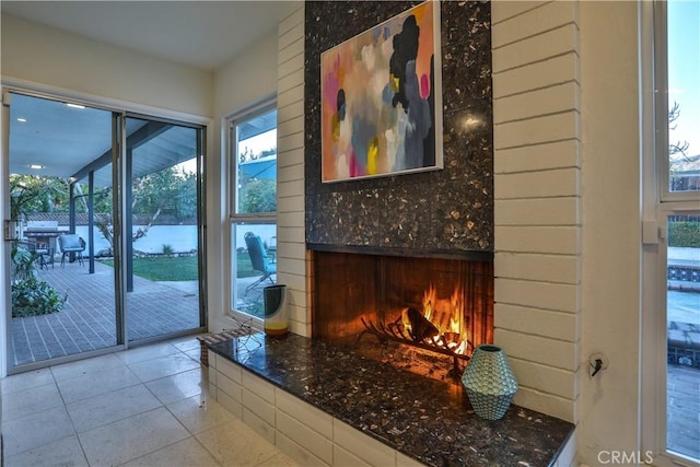 entryway with a large fireplace and a wealth of natural light