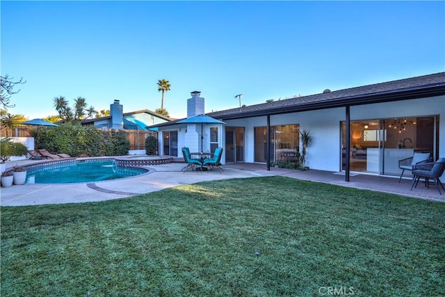 view of swimming pool featuring a yard and a patio