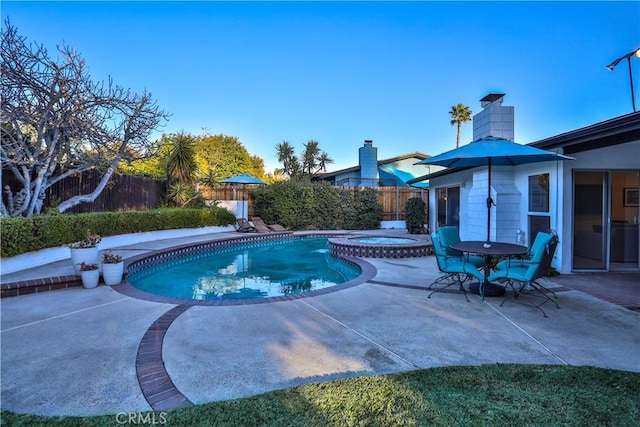 view of pool with a patio and an in ground hot tub