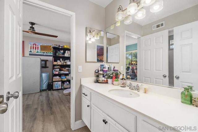 bathroom featuring hardwood / wood-style flooring, vanity, and ceiling fan