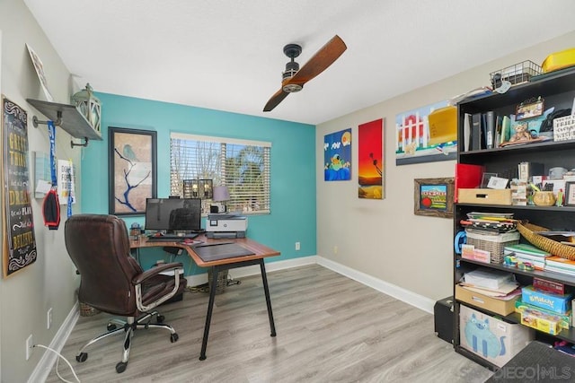 home office with ceiling fan and hardwood / wood-style floors