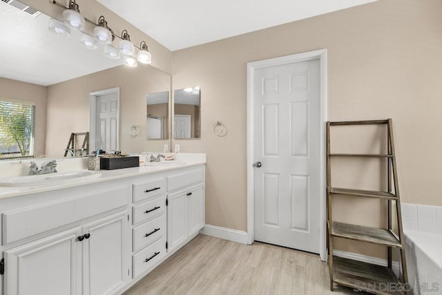 bathroom with vanity and hardwood / wood-style floors