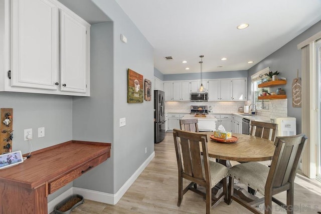 dining room featuring light hardwood / wood-style floors and sink