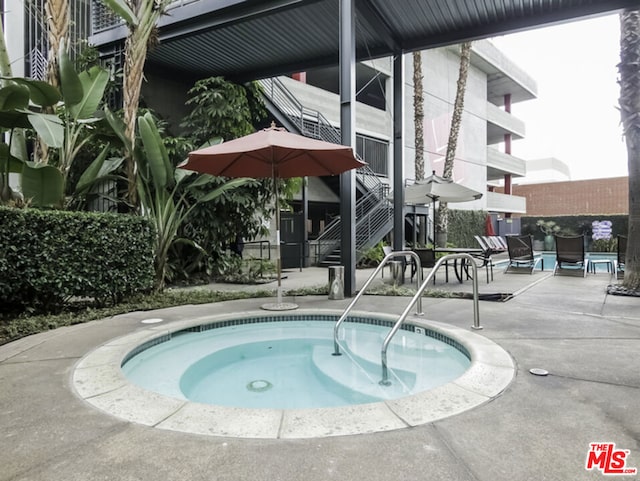 view of pool featuring a patio area and a community hot tub