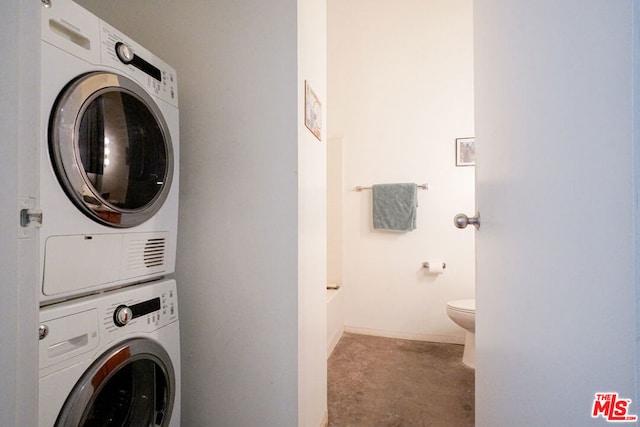 washroom featuring stacked washer / dryer