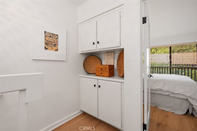 laundry area with light wood-type flooring