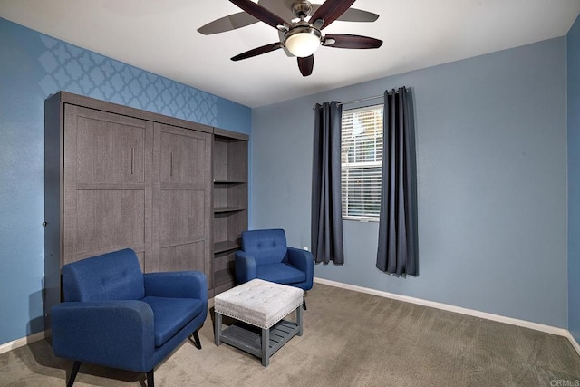 sitting room featuring ceiling fan and carpet floors