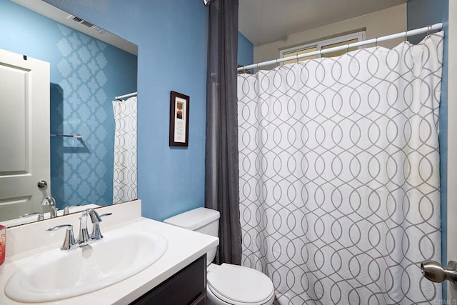 bathroom with toilet and vanity