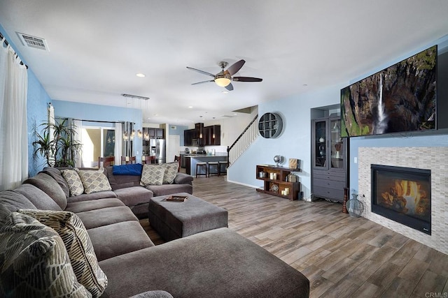 living room featuring ceiling fan and hardwood / wood-style floors