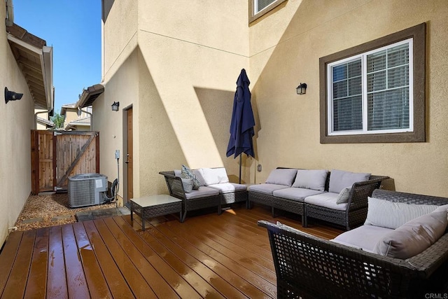 deck with central AC unit and an outdoor living space