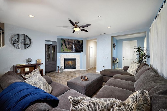 living room featuring ceiling fan and hardwood / wood-style flooring