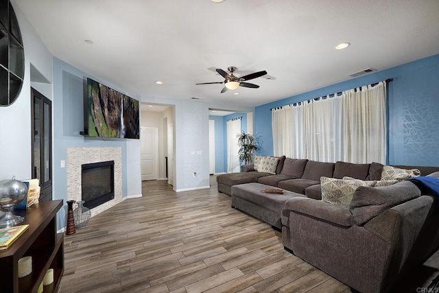 living room featuring ceiling fan and hardwood / wood-style flooring