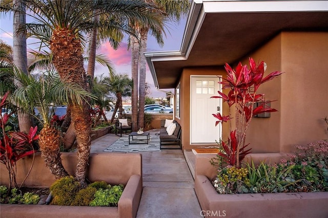 exterior entry at dusk with a patio area