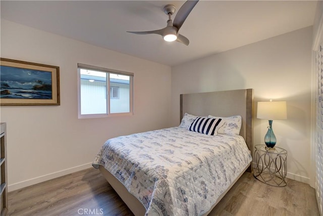 bedroom with ceiling fan and wood-type flooring