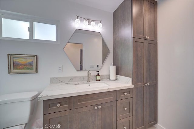 bathroom featuring toilet and vanity