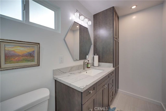 bathroom featuring toilet, vanity, and tile patterned floors