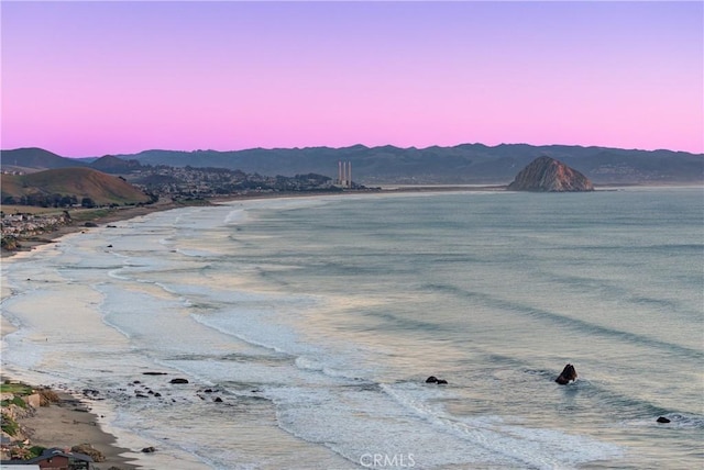 view of water feature with a mountain view and a beach view