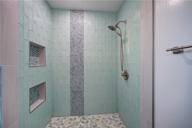 bathroom with tiled shower