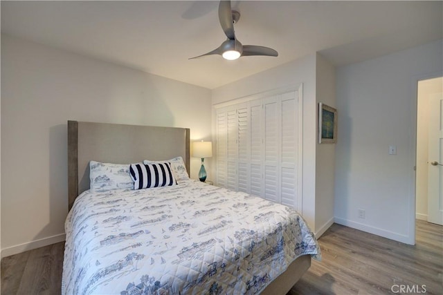 bedroom featuring ceiling fan, a closet, and hardwood / wood-style flooring