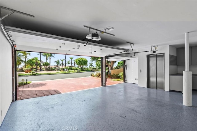 garage with elevator and a garage door opener