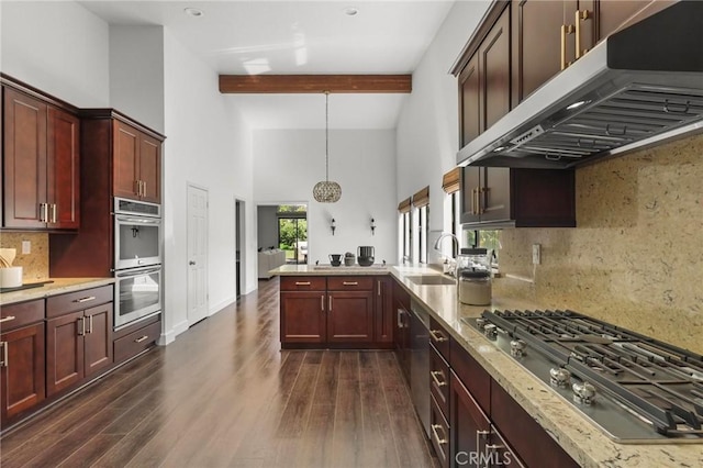 kitchen with dark wood finished floors, stainless steel appliances, a sink, beamed ceiling, and under cabinet range hood