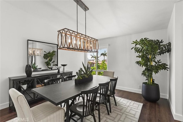 dining space featuring baseboards and wood finished floors