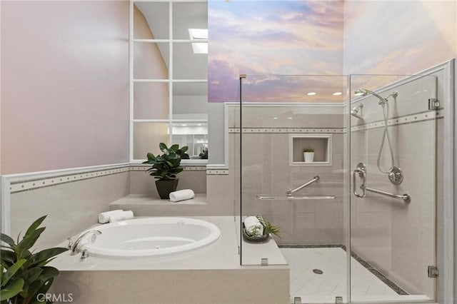 bathroom with a stall shower and a garden tub