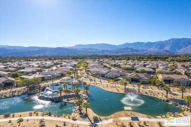 drone / aerial view featuring a water and mountain view