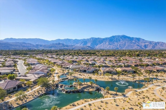 birds eye view of property featuring a water and mountain view