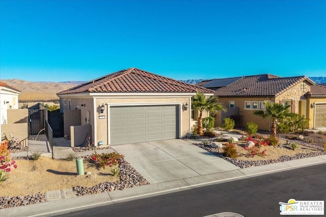 view of front of home with a garage and a mountain view