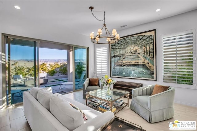 living room featuring a mountain view and a chandelier