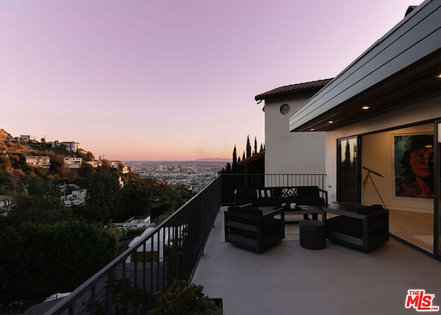 balcony at dusk featuring outdoor lounge area