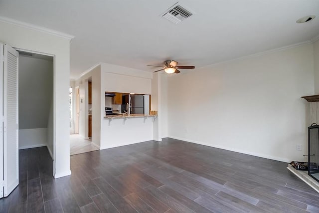 unfurnished living room featuring ceiling fan, dark hardwood / wood-style flooring, and ornamental molding