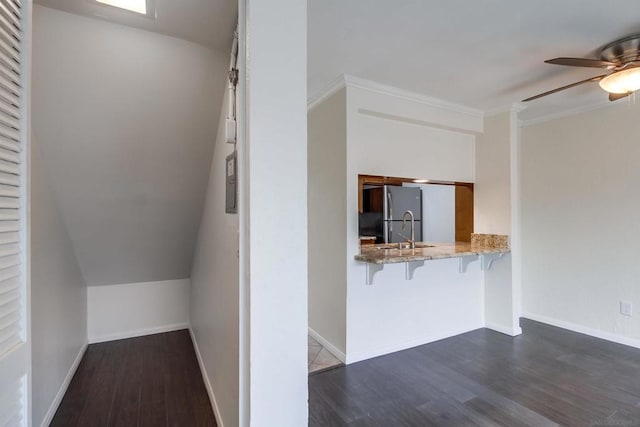 interior space with dark wood-type flooring, sink, and ornamental molding