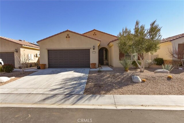 mediterranean / spanish-style home with a garage