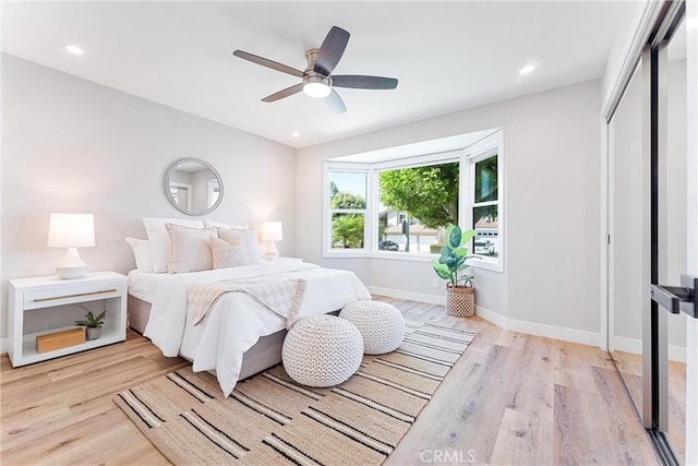 bedroom featuring ceiling fan, a closet, and light hardwood / wood-style floors