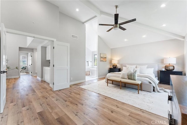 bedroom with ensuite bath, ceiling fan, light hardwood / wood-style floors, and beamed ceiling