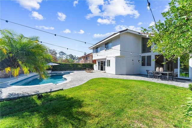 back of house featuring a fenced in pool, a yard, and a patio