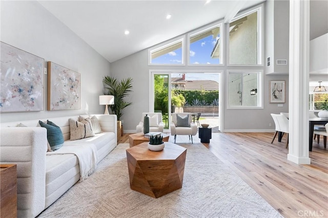 living room featuring lofted ceiling and light wood-type flooring