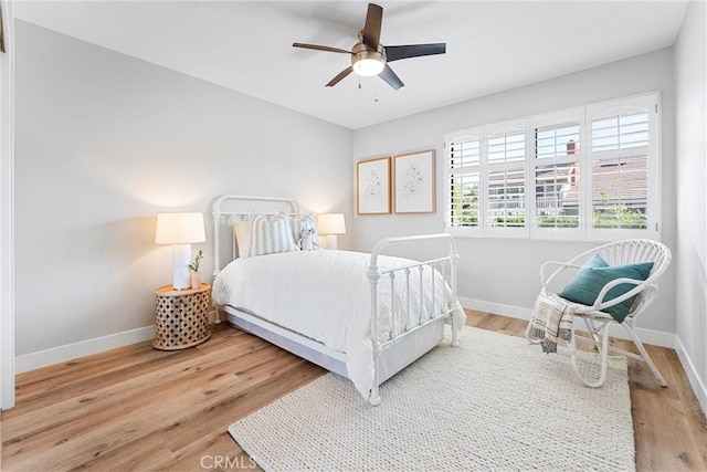 bedroom featuring light wood-type flooring and ceiling fan