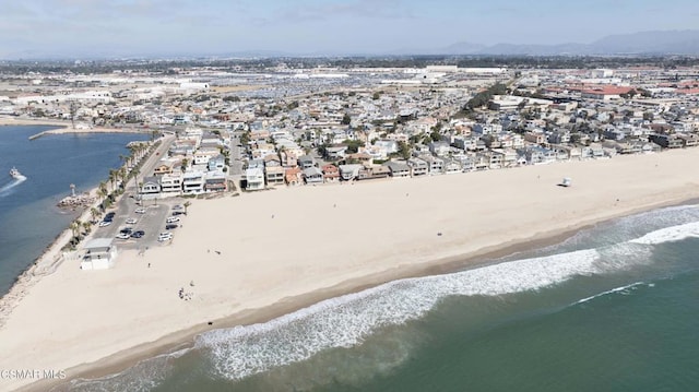 birds eye view of property with a beach view and a water view