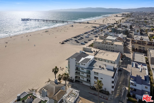 drone / aerial view featuring a beach view and a water view