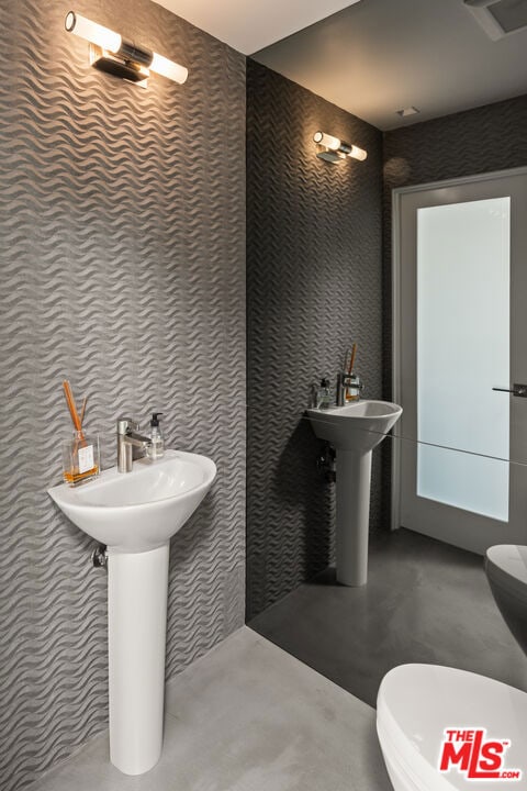 bathroom with toilet and concrete floors