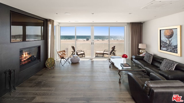 living room featuring a water view and hardwood / wood-style floors