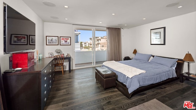 bedroom with access to outside and dark hardwood / wood-style floors