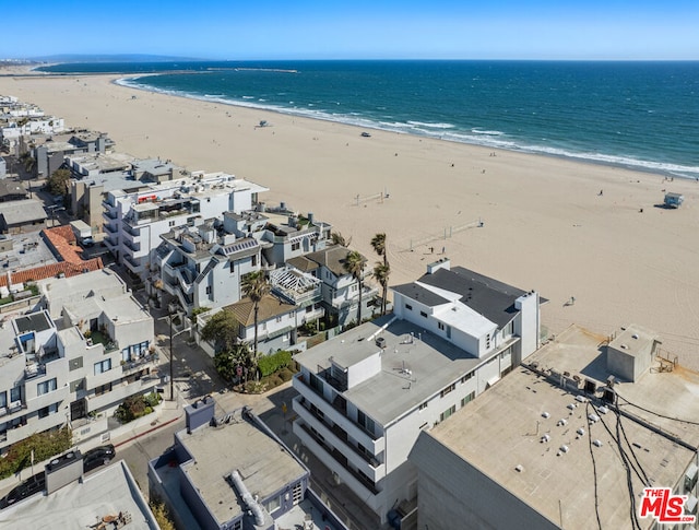 birds eye view of property with a view of the beach and a water view