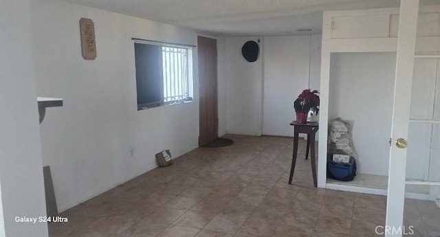 empty room featuring a textured ceiling