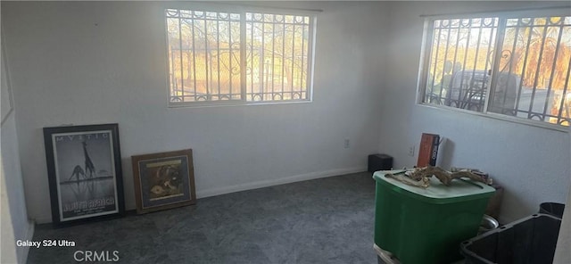 spare room featuring dark colored carpet